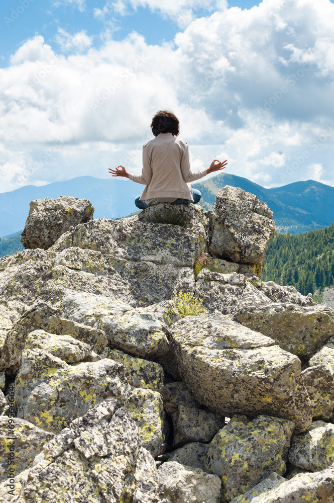 Girl in meditation on Dolomiti - Italy