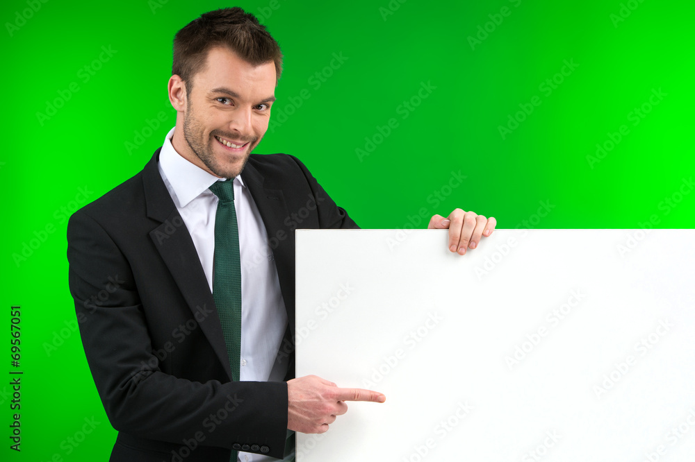 Happy smiling business man showing blank signboard. Happy smiling business man showing blank signboard.