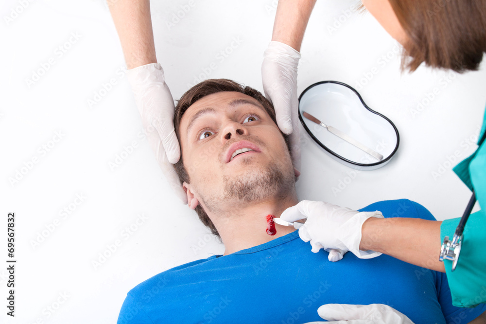 Obraz premium young man lying on floor with blood on neck.