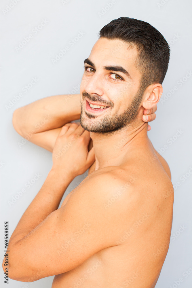 Naklejka premium Handsome man half naked on white background