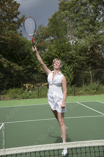 Female tennis player in action on a court