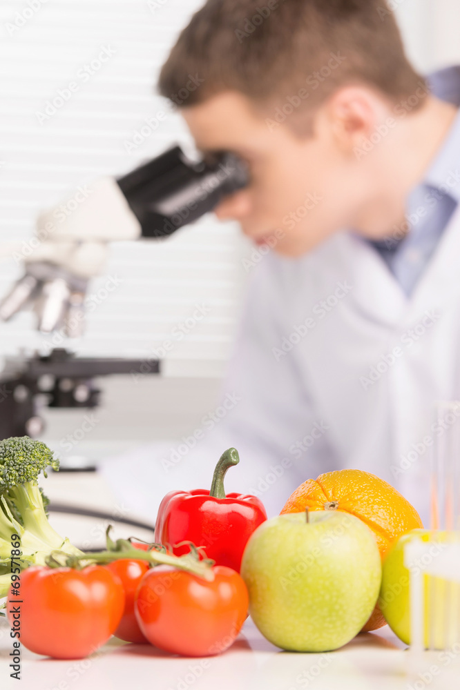 young man studying chemical elements in laboratory. young man studying chemical elements in laboratory.