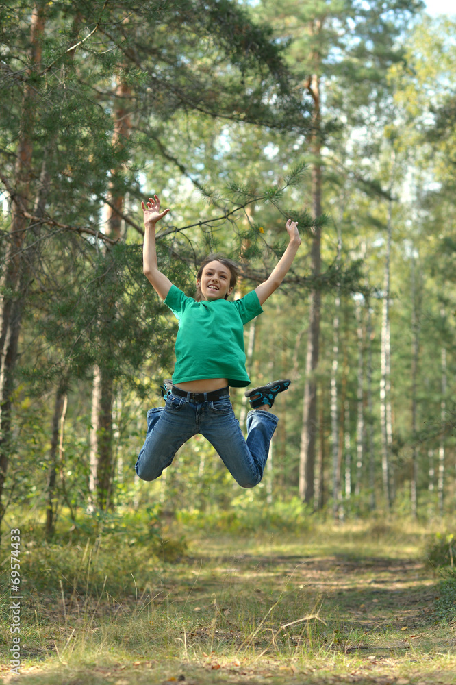 Boy jumping in forest