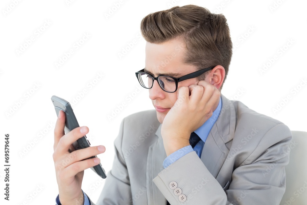 Nerdy businessman looking at his calculator Nerdy businessman looking at his calculator