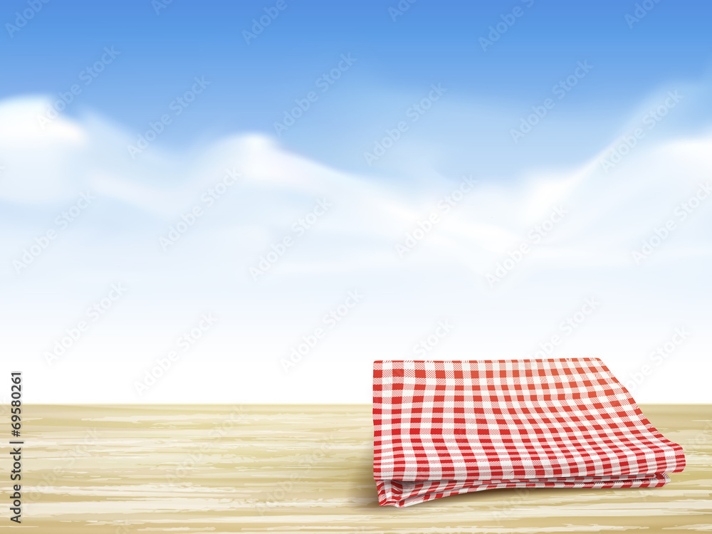 closeup of wooden desk and tablecloth over blue sky closeup of wooden desk and tablecloth over blue sky