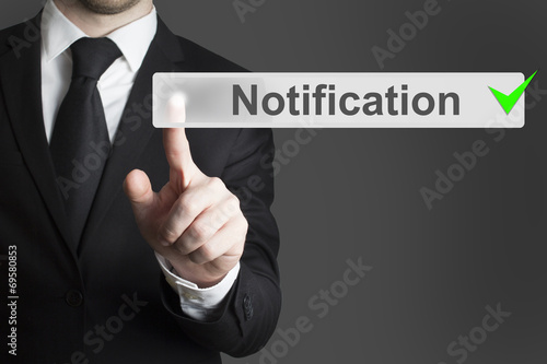businessman pushing button notification