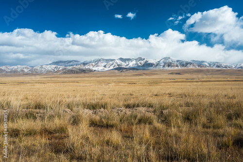 Tibetan highlands and distant snowy mountains near Daotanghe photo