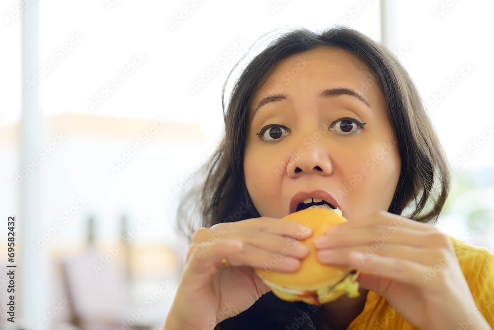 Pretty Young Woman Eating Burger In Cafe Pretty Young Woman Eating Burger In Cafe