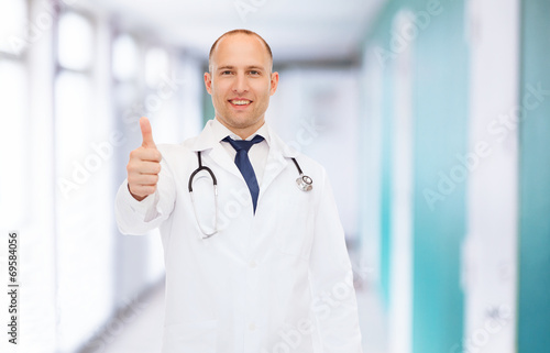smiling doctor with stethoscope showing thumbs up