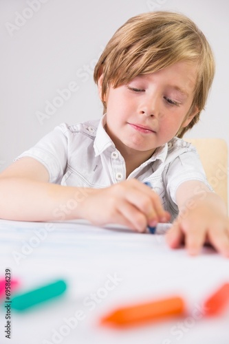 Student using crayons to draw
