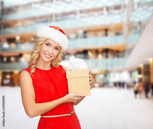 smiling woman in santa helper hat with gift box © Syda Productions