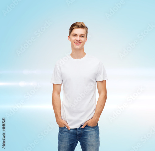 smiling young man in blank white t-shirt © Syda Productions
