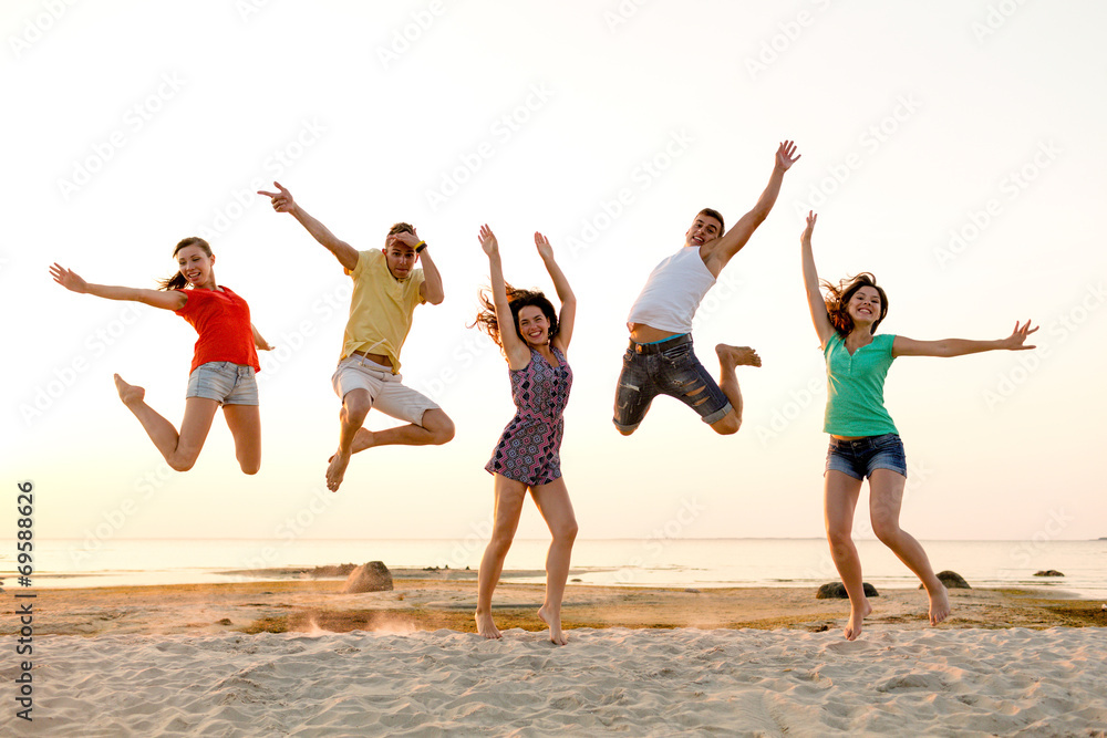 smiling friends dancing and jumping on beach smiling friends dancing and jumping on beach