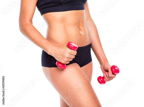 Beautiful slim woman with dumbbells, isolated on white
