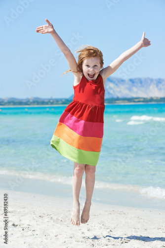 Exciting little girl at sea beach