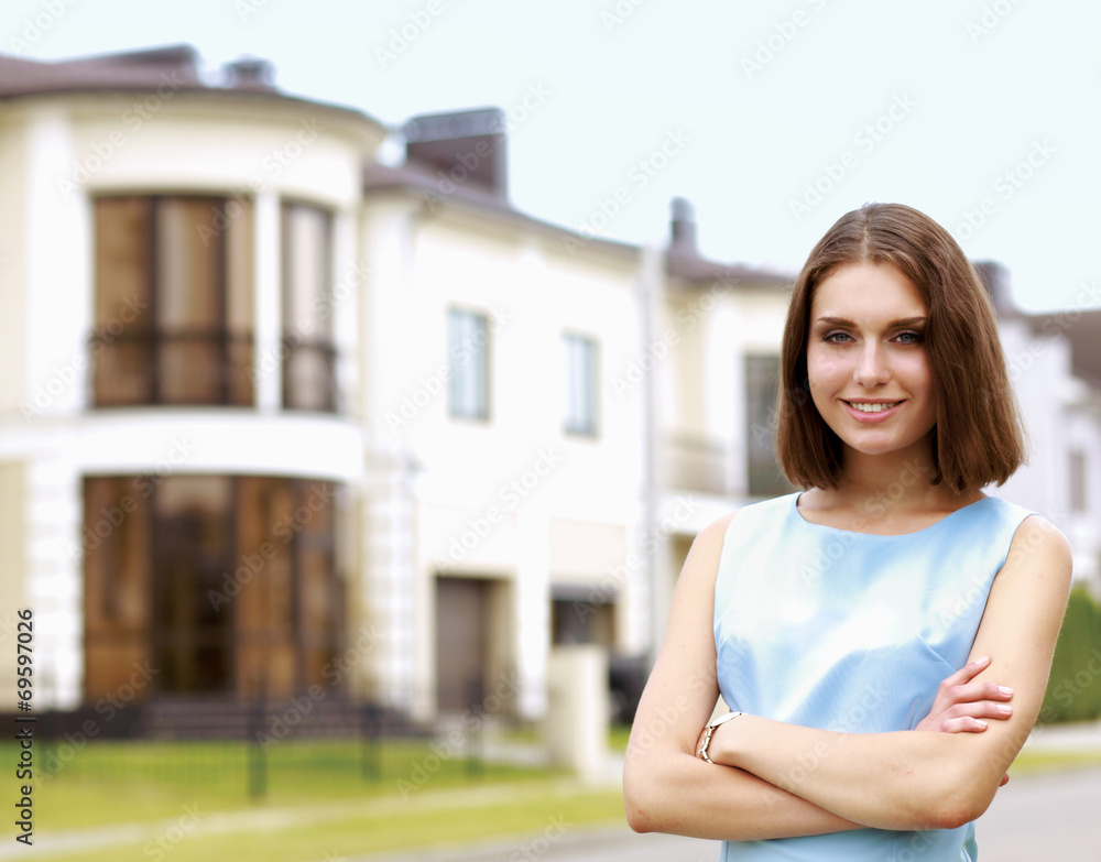 Young woman standing near house, isolated on white