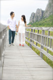 Beautiful married couple on the wooden bridge.