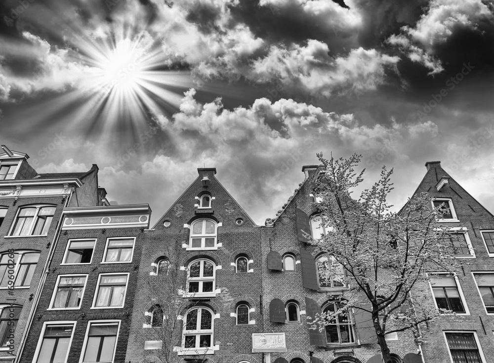 Beautiful Amsterdam typical  buildings with colourful sky