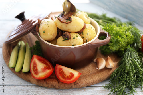 Young boiled potatoes in pan with vegetables