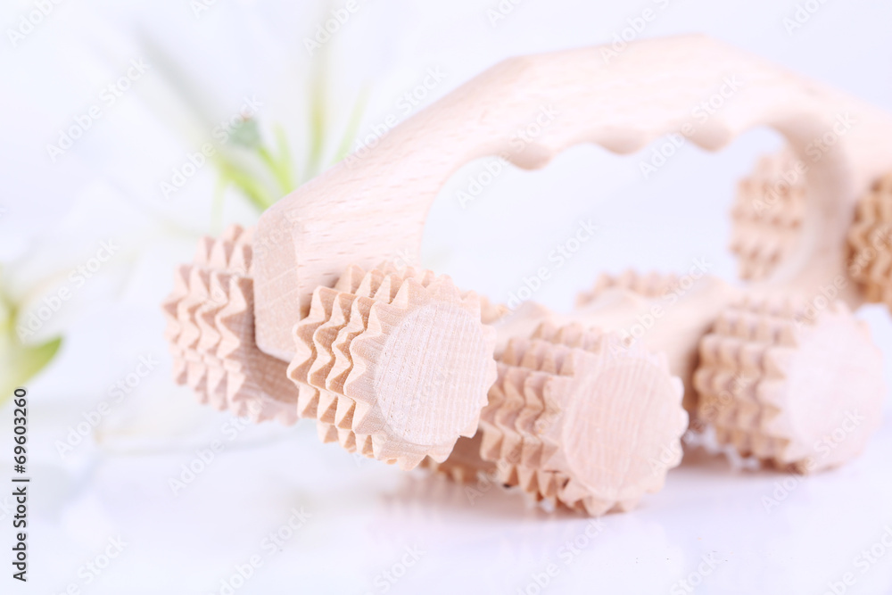 Wooden roller brush and lily on white background isolated Wooden roller brush and lily on white background isolated
