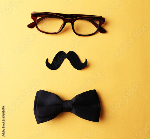 Glasses, mustache and bow tie forming man face