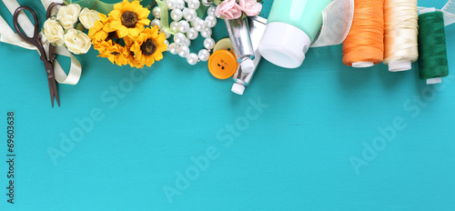 Scrapbooking craft materials on color wooden background photo