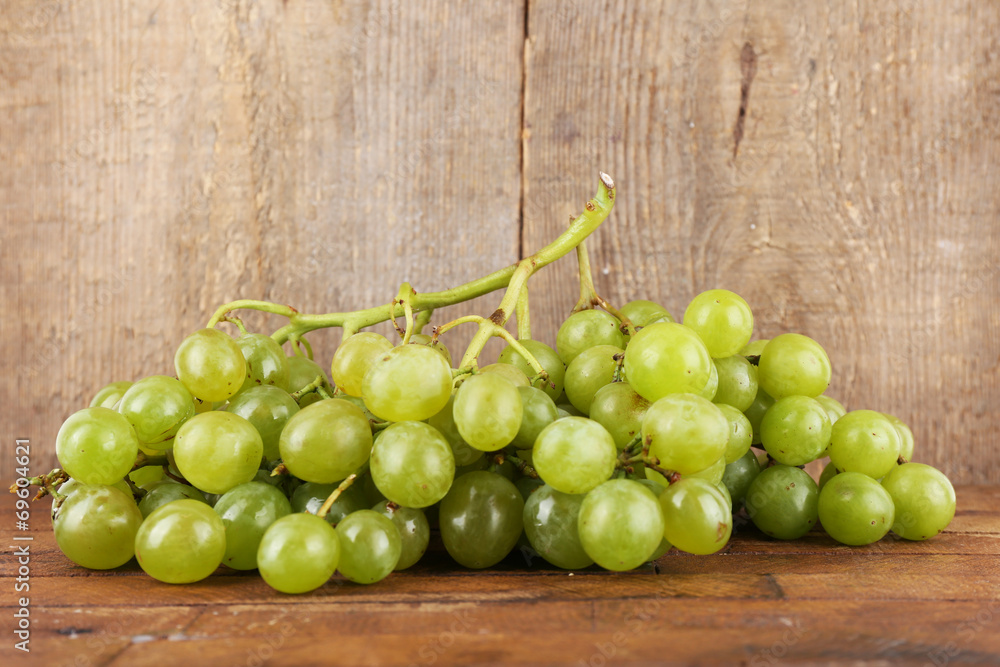 Green grape on wooden table on wooden background Green grape on wooden table on wooden background