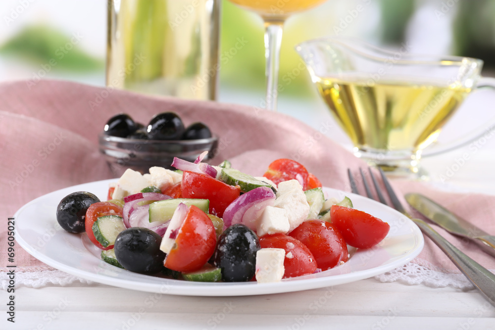 Greek salad served in plate with glass of wine