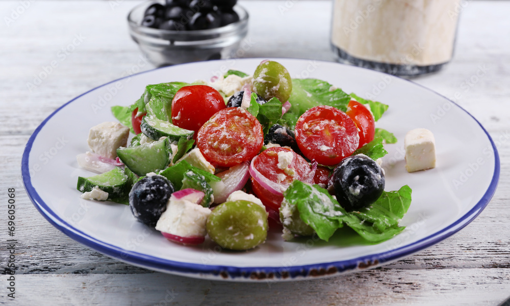 Plate of Greek salad served with olives Plate of Greek salad served with olives
