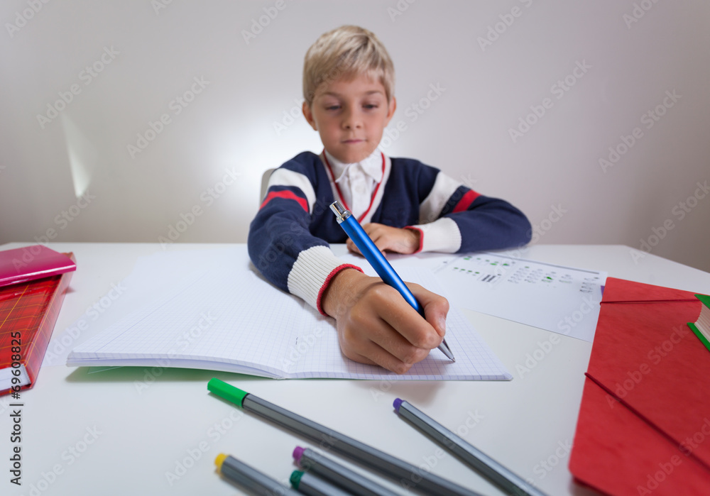 Boy writing something in notebook Boy writing something in notebook