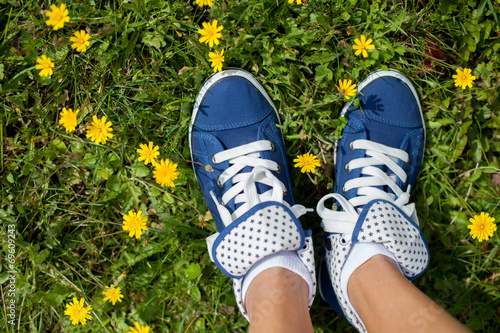 Blue sneakers on girls feet