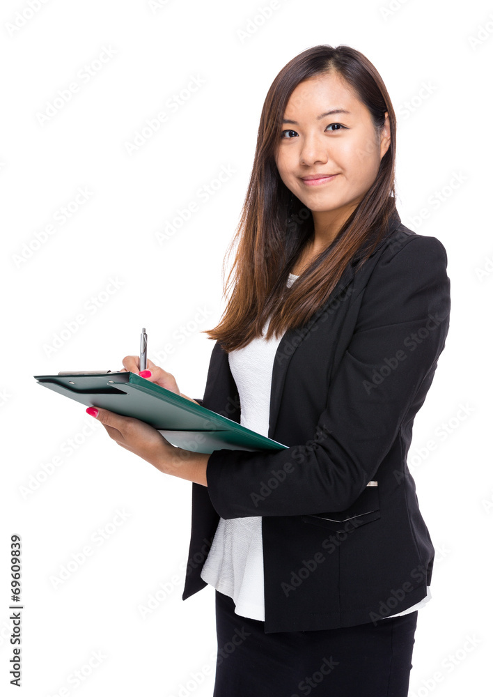 Asian businesswoman write on clipboard Asian businesswoman write on clipboard
