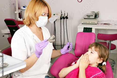 little girl is afraid of the dentist