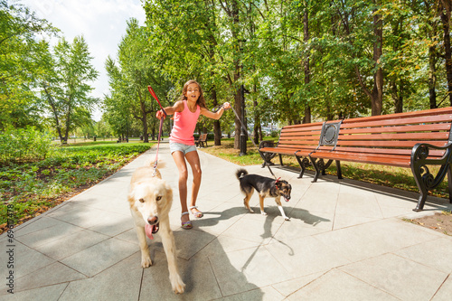 Photography Teenage girl with running away dogs