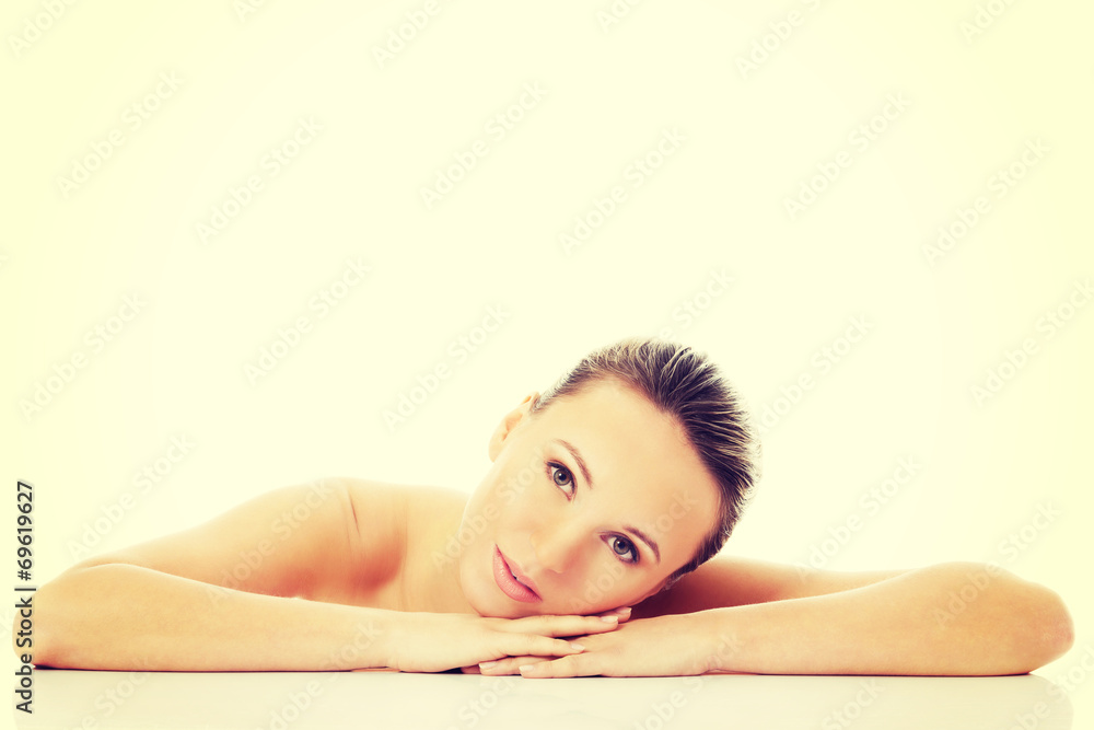 Beautiful nude woman is lying on her hands. Beautiful nude woman is lying on her hands.