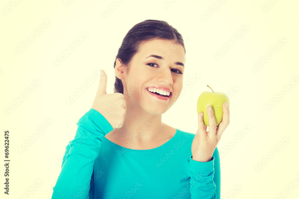 Portrait of a beautiful woman showing ok with apple. Portrait of a beautiful woman showing ok with apple.