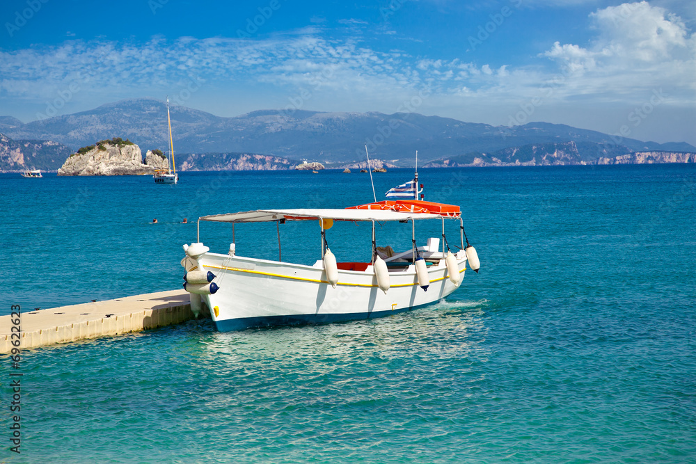 Boat for tourists on Valtos beach near Parga, Greece.