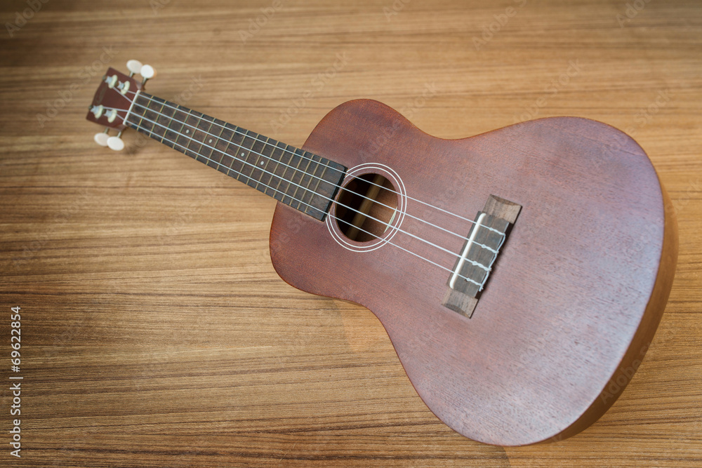 Fototapeta premium Vintage ukulele on wooden background