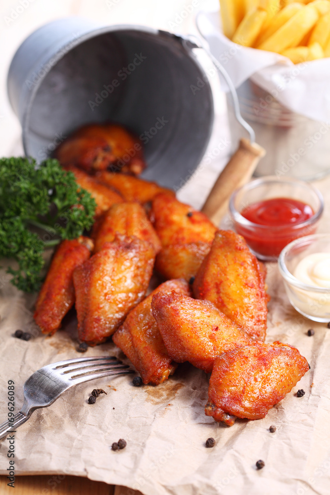 chicken wings with sauce on brown paper