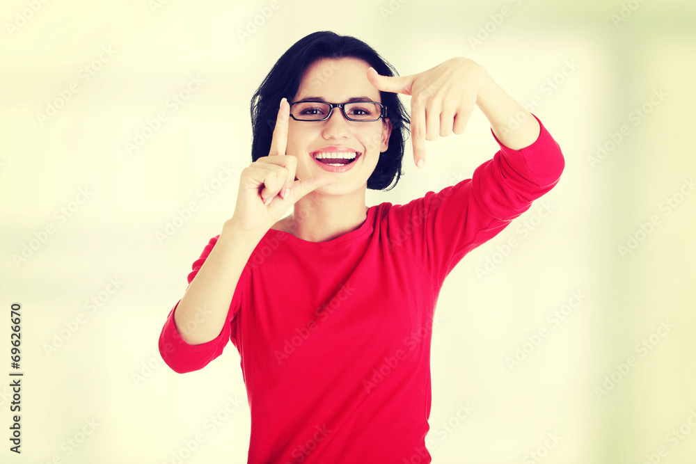 Happy girl with face in frame of palms. Happy girl with face in frame of palms.
