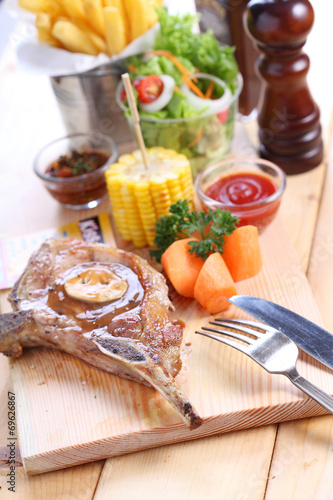 pork steak with spices on wood plate over wooden table