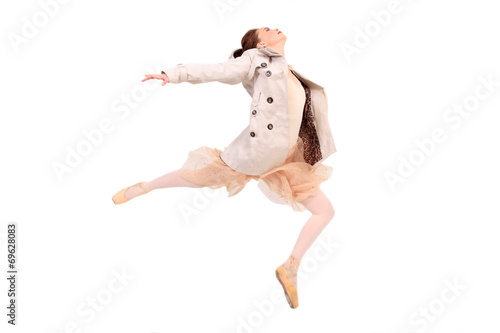Ballerina with jacket and tutu jumping