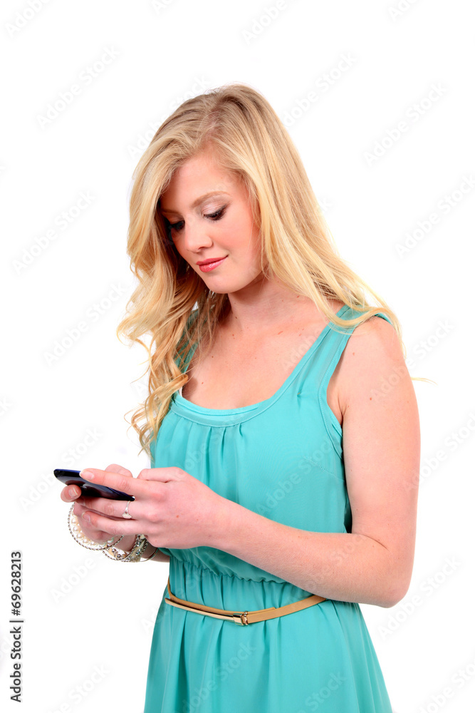 Woman in green dress sending message on mobile