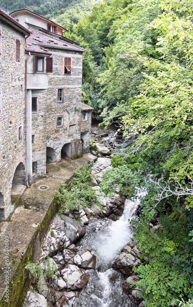 Old mill and stream. Times gone by. Picturesque stone buildings.