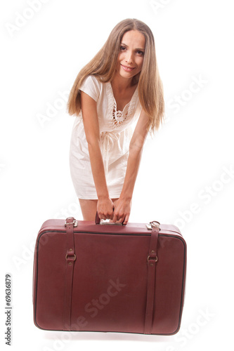 Girl standing with suitcase. Isolated on white