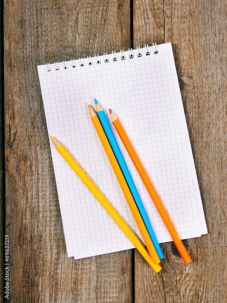 Notebook and pencils on wooden background. Notebook and pencils on wooden background.