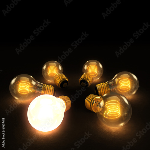 One Bright bulb amoung Six Incandescent Lightbulbs in a circle o