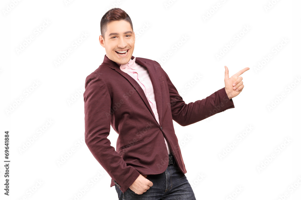 Fashionable smiling guy pointing with hand Fashionable smiling guy pointing with hand