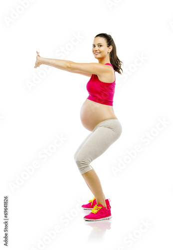 Pregnant fitness woman isolated on white