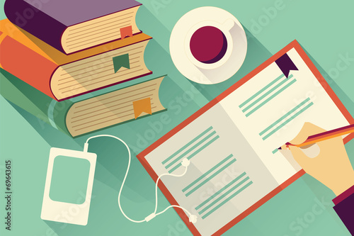 Writing into notebook with stack of books and coffee